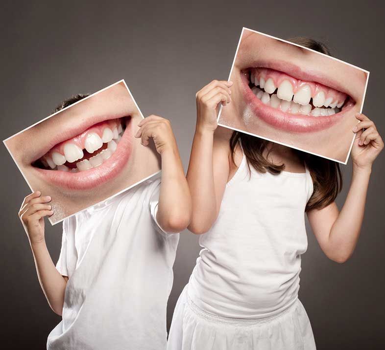 Children holding smile signs