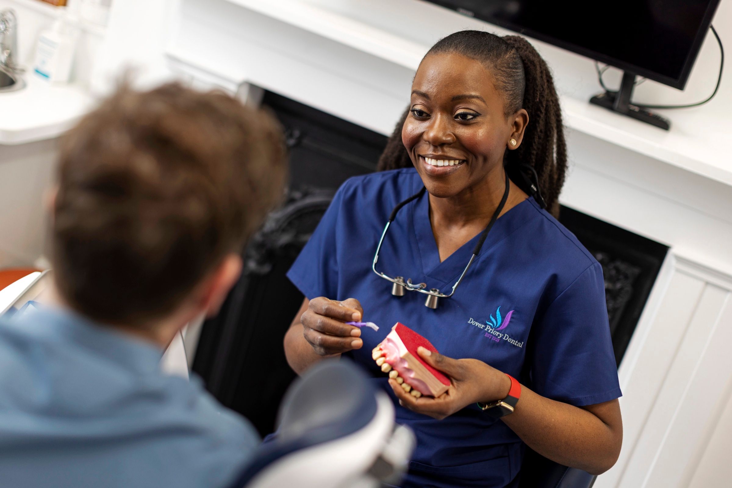 Dr Dorothy Riley explaining treatment with a dental model