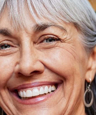 Smiling mature woman after dental implant treatment at Dover Priory Dental