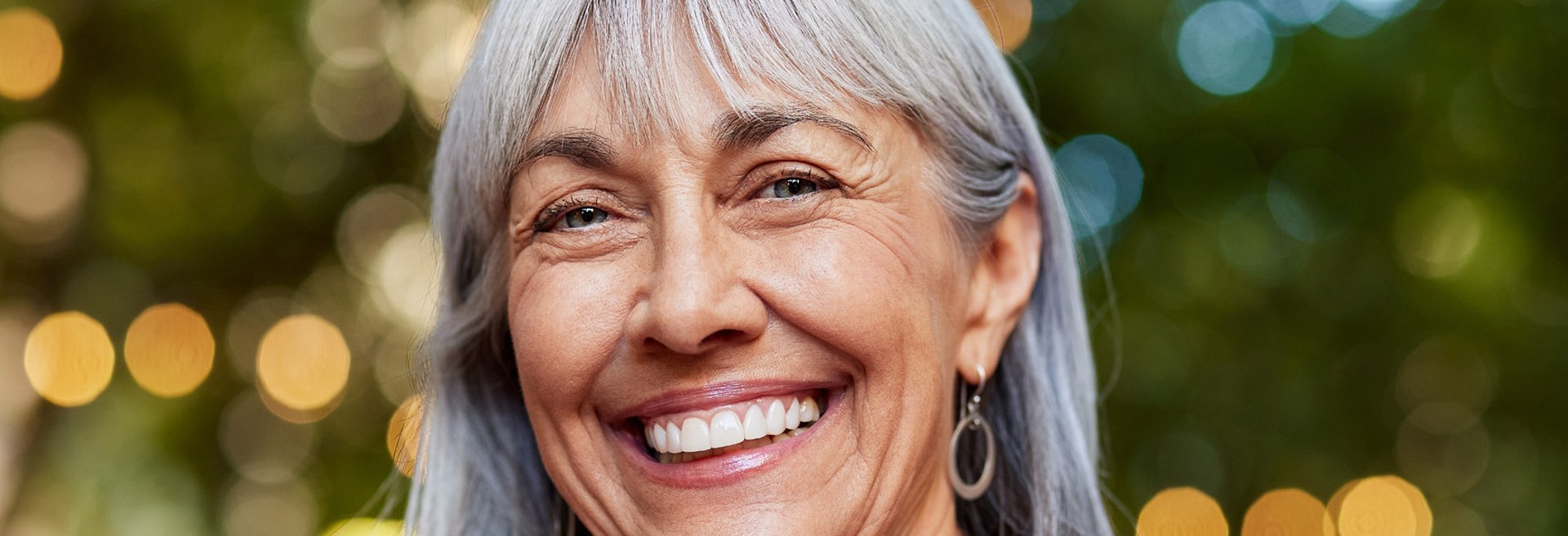Smiling mature woman after dental implant treatment at Dover Priory Dental