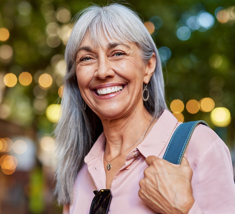 Confident patient smiling following dental implant treatment in Dover
